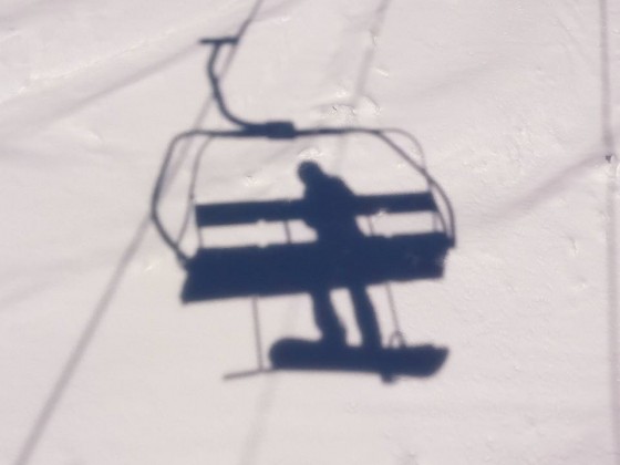 The shadow of La Serra chairlift on a sunny day in Pal
